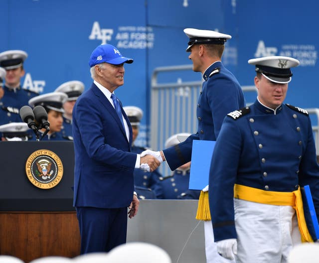 A cadet shakes hands with President Joe Biden after receiving his diploma during the United States Air Force Academy graduation ceremony at Air force Academy, Colorado