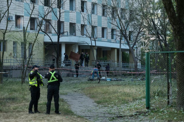 Police inspect a building damaged by a Russian night attack in Kyiv