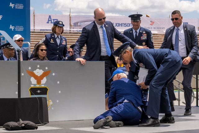 President Joe Biden falls on stage during the 2023 United States Air Force Academy Graduation Ceremony at Falcon Stadium at the United States Air Force Academy in Colorado Springs, Colorado