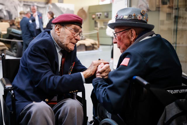 British Second World War veteran Bill Gladden, left, with US veteran Jack M Larson in the Pegasus Bridge memorial in Benouville, Normandy, on Monday