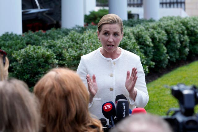 Denmark’s Prime Minister Mette Frederiksen speaks with reporters