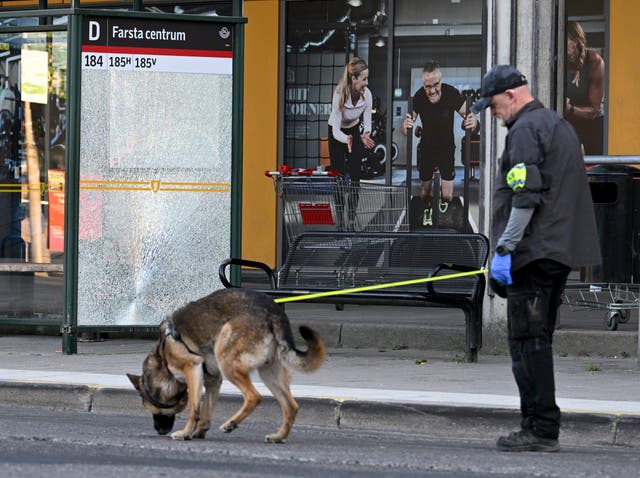 Police at the scene after a shooting incident, in Farsta, southern Stockholm, in June 2023