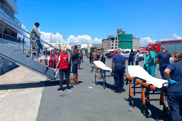 Survivors arrive by yacht at the port in Kalamata town 