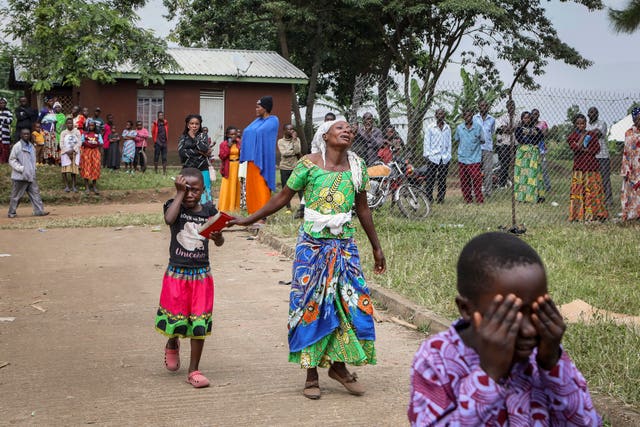 Relatives grieve as they wait to collect the bodies of villagers who were killed in the attack 