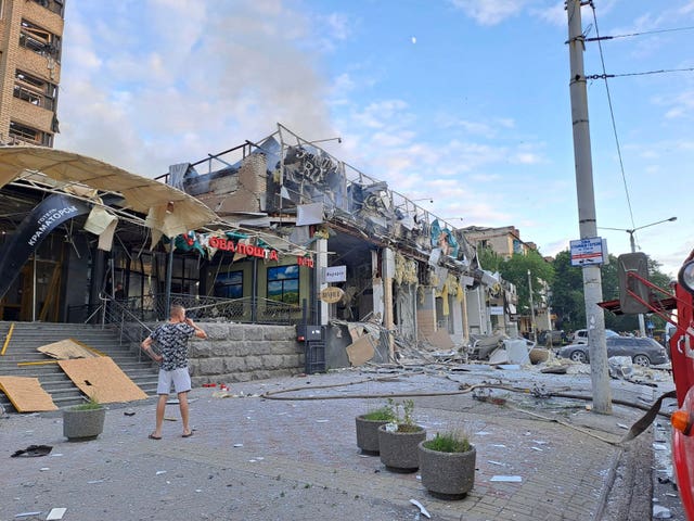 A man stands on the  street in front of the restaurant destroyed by a missile attack in Kramatorsk