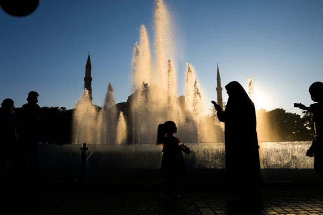 Muslims gather after the Eid prayers, outside the Haghia Sophia mosque in the Sultan Ahmed district of Istanbul on Wednesday