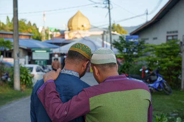 Muslims walk to a mosque for morning prayer during Eid in Selayang on the outskirts of Kuala Lumpur, Malaysia