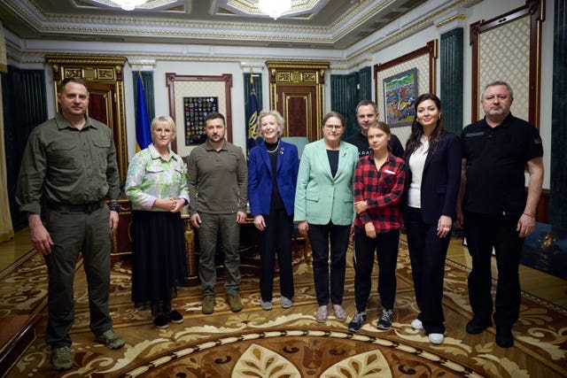 Ukrainian President Volodymyr Zelensky, third from left, poses for a photograph with Greta Thunberg, third right, vice president of the European Parliament Heidi Hautala, centre, ex-deputy prime Mminister and ex-minister of foreign affairs of Sweden Margot Wallstrom, second from left, president of Ireland from 1990-1997 Mary Robinson, fourth from left, and Ukrainian officials during their meting in Kyiv