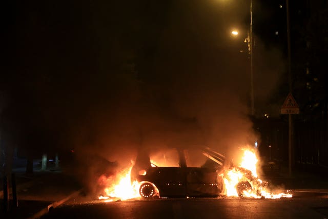 A car burns during protests