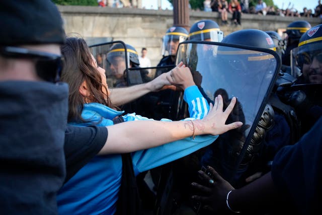 Police officers face protesters on Concorde square during a protest in Paris