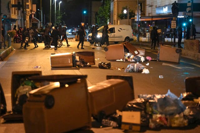 Protesters block a street with rubbish bins in Colombes, outside Paris 