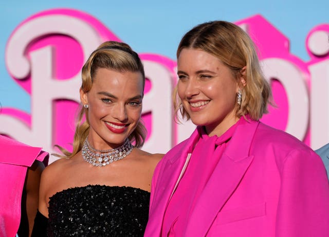Margot Robbie, left, and writer/director/executive producer Greta Gerwig arrive at the premiere of Barbie at The Shrine Auditorium in Los Angeles