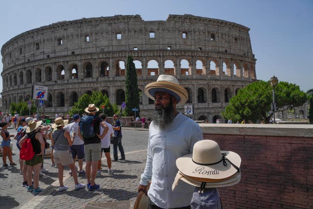 A street vendor with hats in front of the Colosseum in Rome