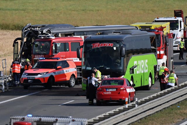Firefighters and police officers at the scene of a crash between two buses on the D2 motorway near Brno, Czech Republic 