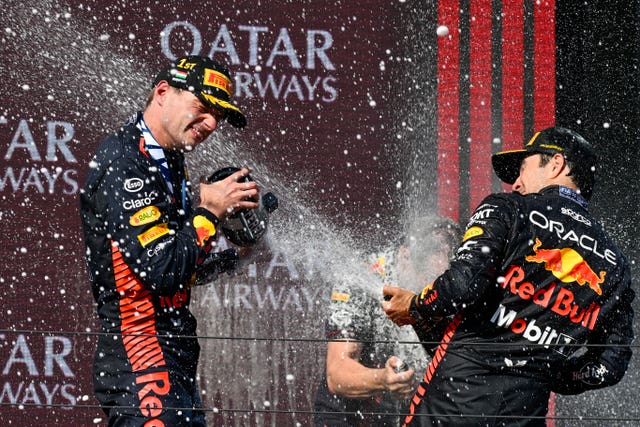 Max Verstappen, left, sprays champagne on the podium with third-placed team-mate Sergio Perez in Hungary