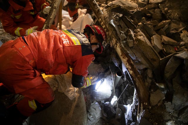 Rescuers search for trapped victims