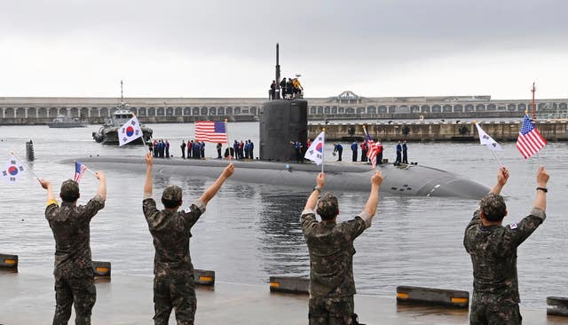 South Korean navy sailors wave as the USS nuclear-powered submarine USS Annapolis arrives at a naval base on Jeju Island