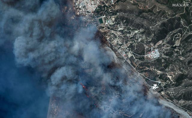 This image provided by Maxar Technologies shows an active wildfire near Genadi on the island of Rhodes, Greece