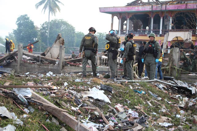 A Thai bomb squad examines the site of an explosion at a firework warehouse in Narathiwat province, southern Thailand