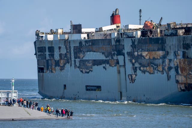 Stricken cargo ship Fremantle Highway, that caught fire while transporting thousands of cars, including nearly 500 electric vehicles, from Germany to Singapore, is towed into the port of Eemshaven, the Netherlands