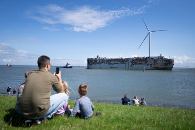 Stricken cargo ship Fremantle Highway, that caught fire while transporting thousands of cars, including nearly 500 electric vehicles, from Germany to Singapore, is towed into the port of Eemshaven, the Netherland