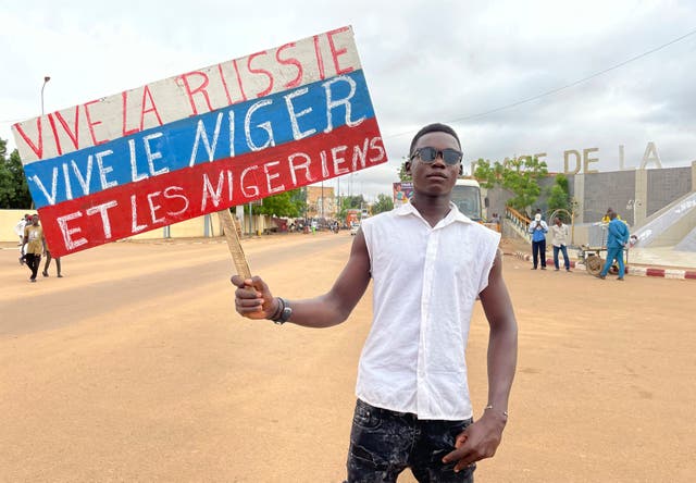 A supporter of Niger’s ruling junta holds a placard in the colors of the Russian flag reading 'Long Live Russia, Long Live Niger and Nigeriens' at the start of a protest called to fight for the country’s freedom and push back against foreign interference in Niamey, Niger, on Thursday 