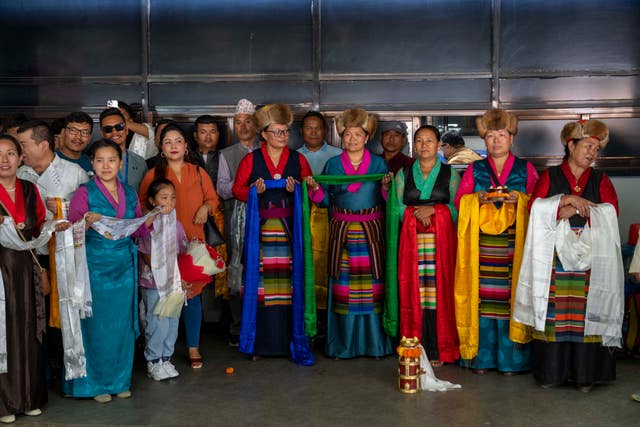 Family and friends wait to welcome Norwegian woman mountain climber Kristin Harila, and her Nepali Sherpa guide Tenjen Sherpa, who on Thursday set a new record by scaling the world’s 14 highest peaks in 92 days as they arrive at the airport in Kathmandu, Nepal