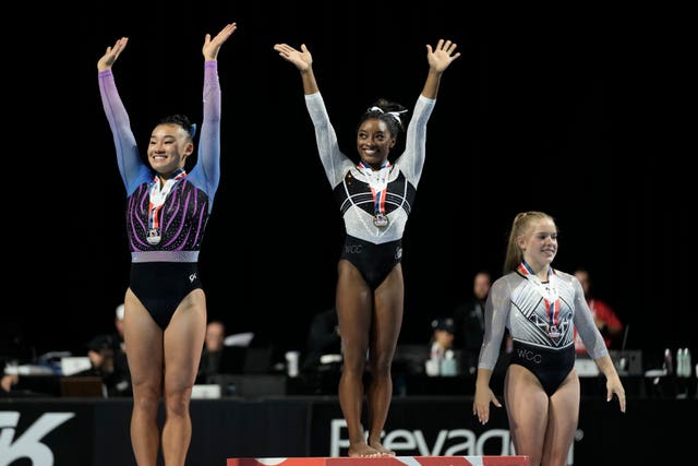 Simone Biles (centre) celebrates after winning all-around at the US Classic gymnastics competition on her return to the sport after a two-year absence