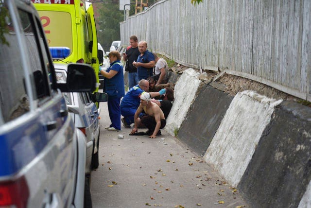 Emergency medics treat injured people at the factory