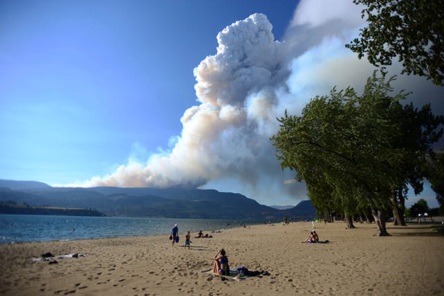 Smoke from a wildfire is seen over Okanagan Lake from Kelowna, British Columbia 