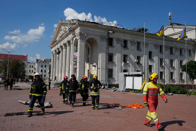 Firefighters near damaged buildings in Chernihiv, Ukraine