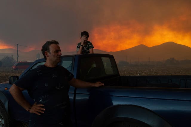 Local residents watch the wildfire in Avanta