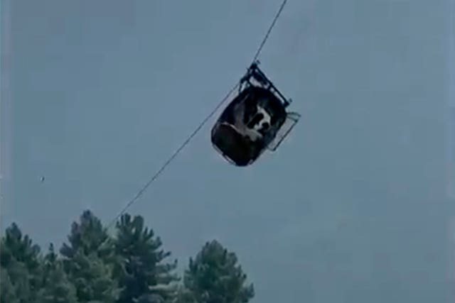 The cable car dangling hundreds of feet in the air