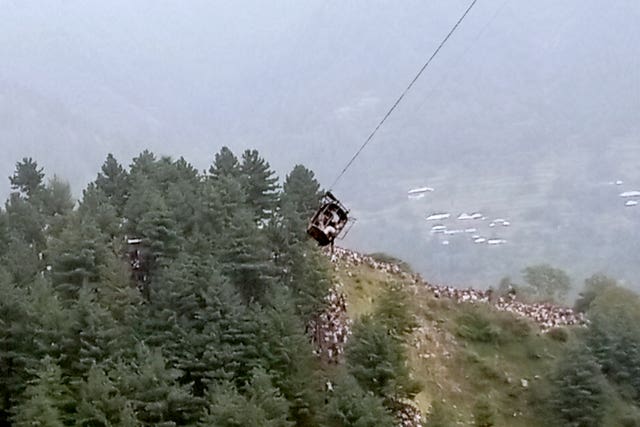The cable car dangling hundreds of feet above the ground