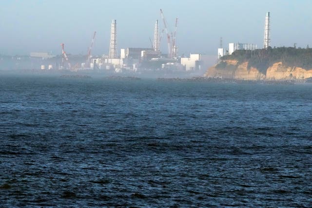 The Fukushima Daiichi nuclear power plant, damaged by a massive March 11, 2011, earthquake and tsunami, is seen from the nearby Ukedo fishing port in Namie town, north-eastern Japan
