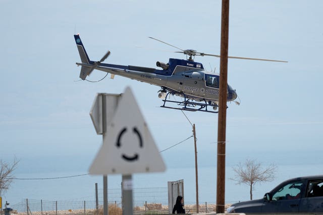 An Israeli police helicopter works at the site of a rockslide that took place in the Ein Gedi Nature Reserve, on the western shore of the Dead Sea, a popular tourist site in Israel 