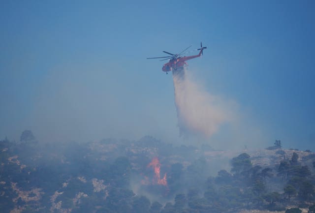 Firefighting helicopter drops water