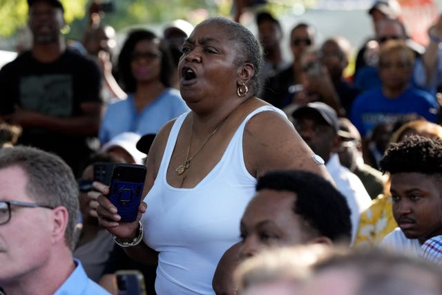 A local resident shouts as Ron DeSantis makes remarks during a prayer vigil for the victims of Saturday’s shooting