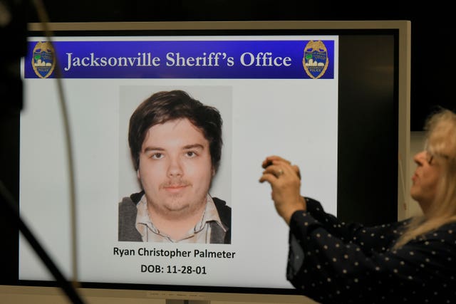 Christopher Palmeter is shown on a video monitor during a police press conference