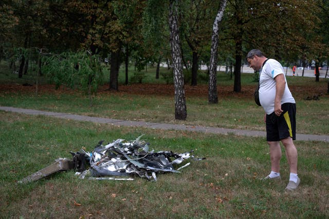 Someone looks at a rocket fragment