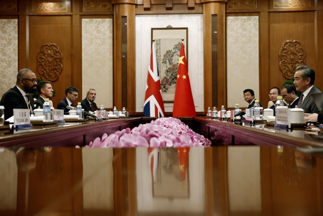 Mr Cleverly, left, attends a meeting with Chinese foreign minister Wang Yi, right, in Beijing 