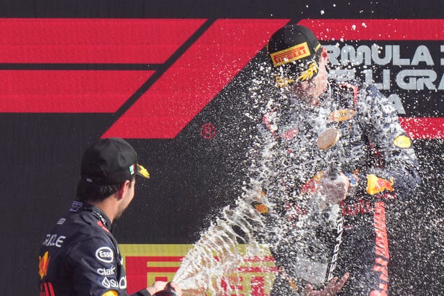 Sergio Perez, left, sprays champagne at Max Verstappen on the Italian Grand Prix podium