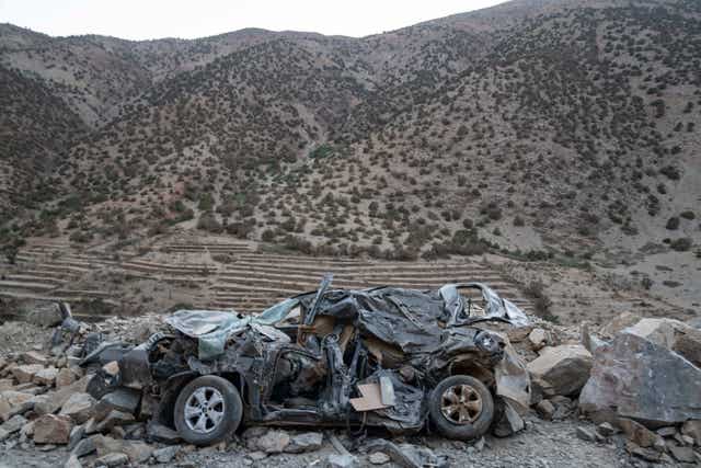 A car heavily damaged by the earthquake is left on the side of a road 