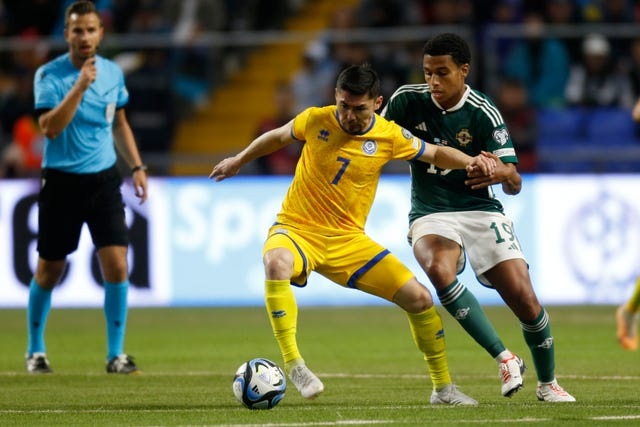Northern Ireland’s Shea Charles, right, fights for the ball with Kazakhstan’s Aslan Darabayev (Stas Filippov/AP)