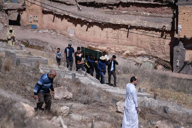 People carry a coffin of an earthquake victim in Moulay Brahim in the province of Al Haouz 