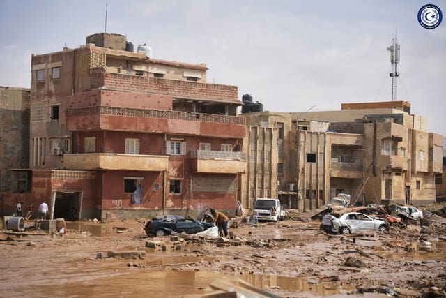 Cars and rubble in a street in Derna, Libya