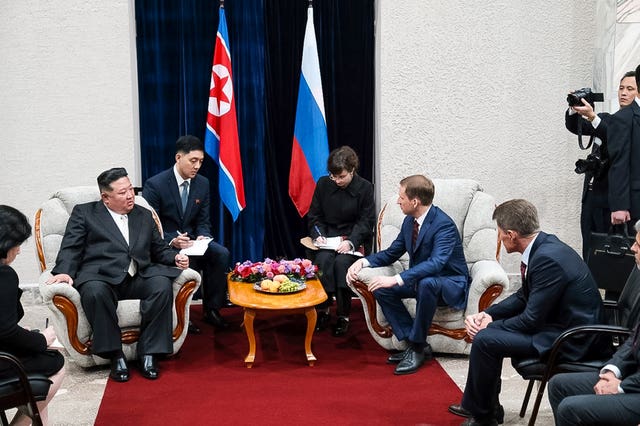 North Korea’s leader Kim Jong Un, left, is greeted by Russian minister of natural resources and ecology Alexander Kozlov, sits right, after crossing the border to Russia at Khasan, about 127km (79 miles) south of Vladivostok