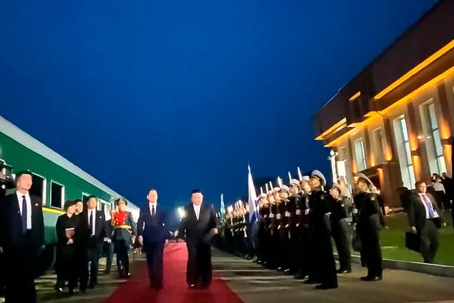 Kim Jong Un, centre right, attends a welcome ceremony after crossing the border to Russia at Khasan, about 127km (79 miles) south of Vladivostok