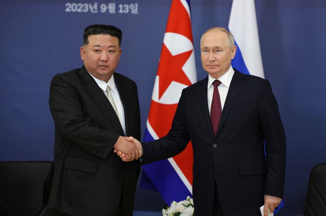Russian President Vladimir Putin, right, and North Korean leader Kim Jong Un shake hands during their meeting at the Vostochny cosmodrome 