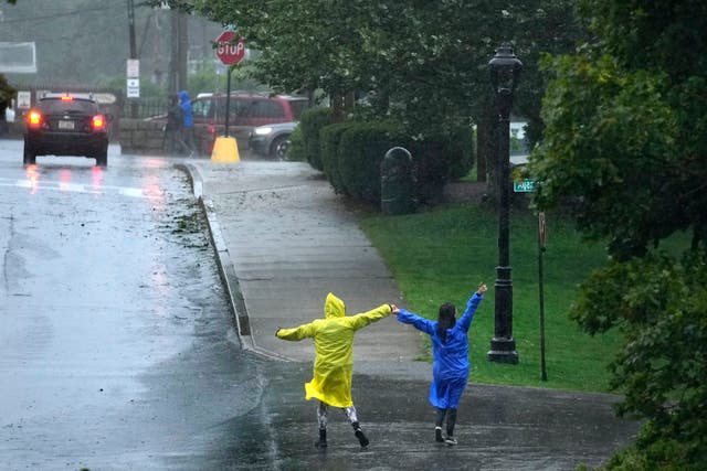 People dance in rain